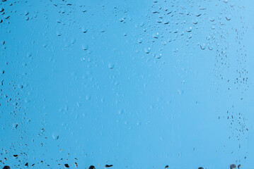 Blue backgrond with water drops. Wet glass.
