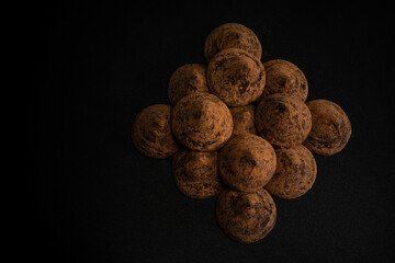Chocolate truffles on a black background.