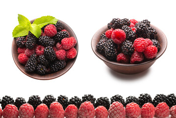 Raspberries and blackberry in a row isolated on white background.