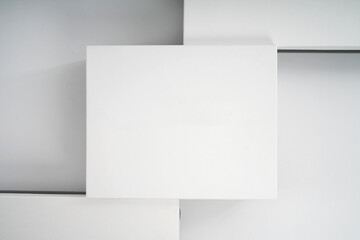 white cardboard boxes for shoes and storage of things on a light background close-up top view