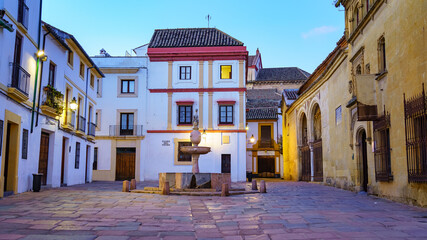 Picturesque square with typical buildings at sunset in the city of Cordoba. Spain.