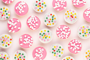 Colorful cupcakes on a white background.