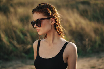 woman in sunglasses eating chips in nature sun