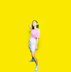 Fototapeta na wymiar Young confident asian woman posing wearing headphones indoor isolated cropped copy space banner background