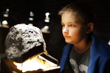 Kid examines natural mineral