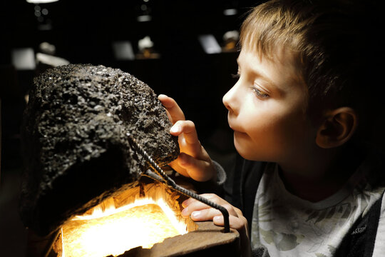 Boy examines natural mineral