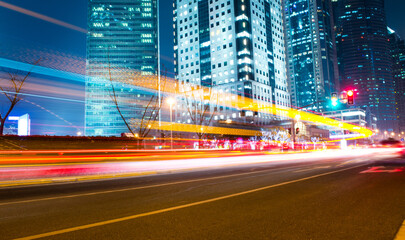 Fototapeta na wymiar moving car with blur light through modern city at night.