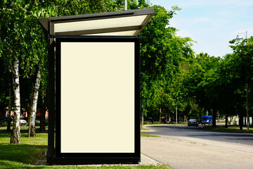 blank bus shelter and bus stop. glass and aluminum frame structure. urban park setting. composite...
