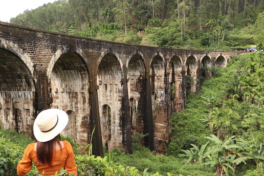 Woman stands at a famous bridge in Sri Lanka