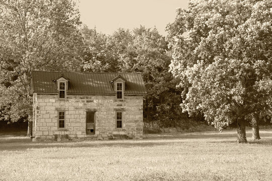 Rural pioneer days homestead building abandoned and deserted old sepia style vintage photograph