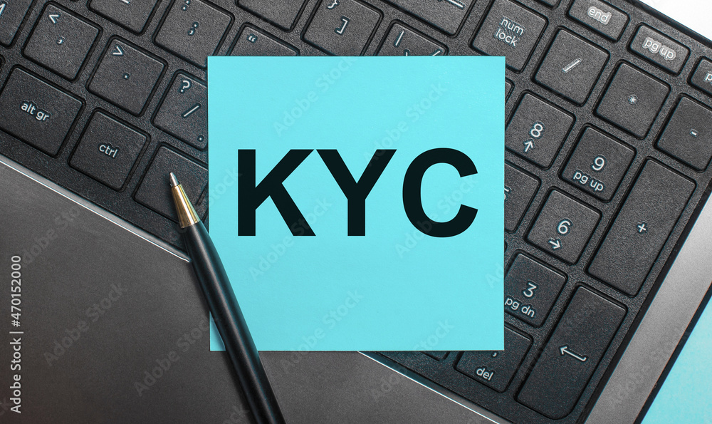 Poster the computer keyboard has a pen and a blue sticker with the text kyc know your customer. flat lay.
