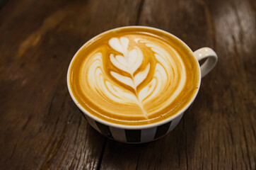 Coffee latte art on wooden table