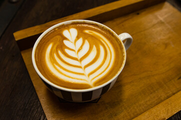 Coffee latte art on wooden table