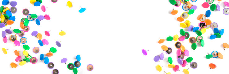 Set of colored push stationery pins on white background. Panorama.