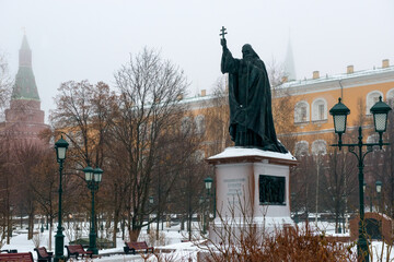 Monument to Patriarch Hermogenes in Alexander garden in the fog. Misty winter morning in Moscow.