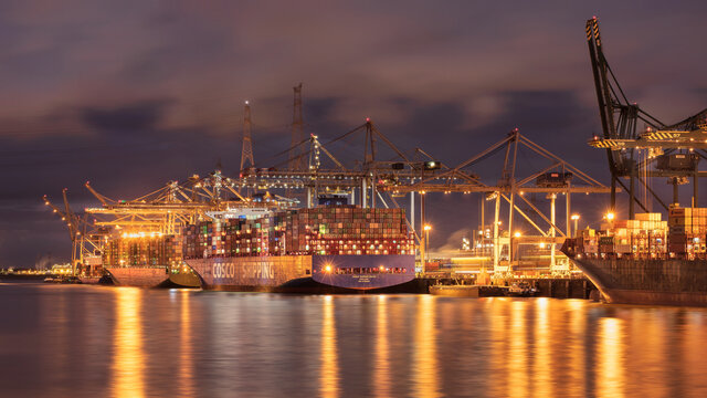 ANTWERP-NOV 13, 2021. Illuminated container terminal at twilight. Thanks to its very high productivity, Antwerp is one of the fastest growing container ports of the European industrial area.