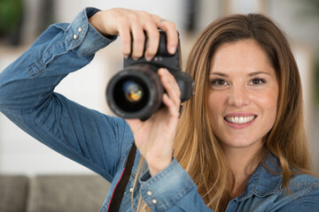 portrait of a female photographer holding a camera