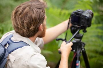 photographer as a nature photographer with camera and tripod