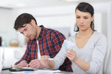 worried couple using pay their bills at home
