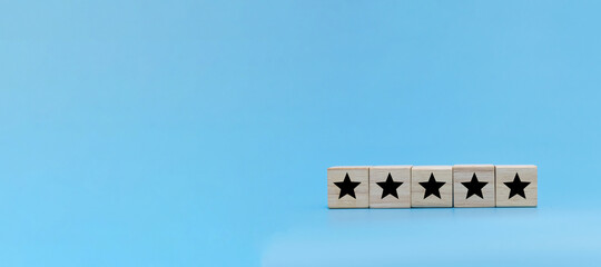 High Quality. five star icon on wooden cube block stack on blue background, customer feedback,...