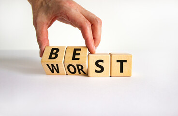 Best or worst symbol. Businessman turns wooden cubes and changes the word best to worst. Beautiful...