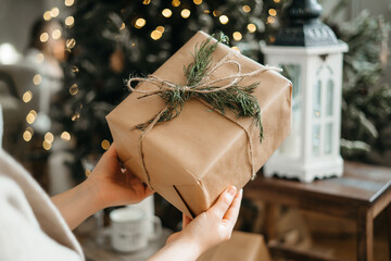 Focus on wrapped Christmas present congratulating with winter holidays, reminding preparing gifts,...