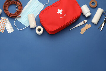 Flat lay composition with first aid kit on blue background, space for text - obrazy, fototapety, plakaty