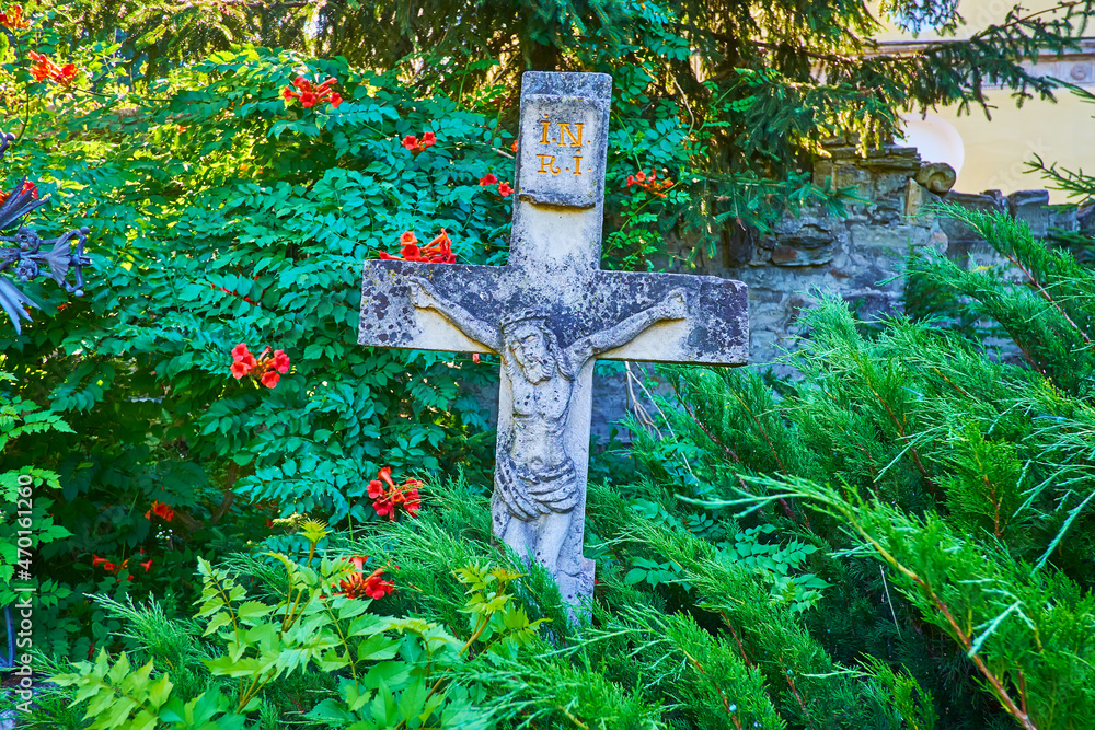 Sticker The medieval gravestone amid the greenery of Kamianets-Podilskyi Cathedral garden, Ukraine