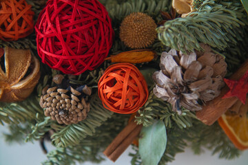 Christmas Holiday Wreath Isolated On Background. Wreath made of natural fir branches hanging with natural ornaments: bumps, cones, garlands, stars.