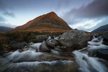 cascade waterfalls and fairy pools with the Devils point mountain located in the Cairngorms, highlands Scotland.