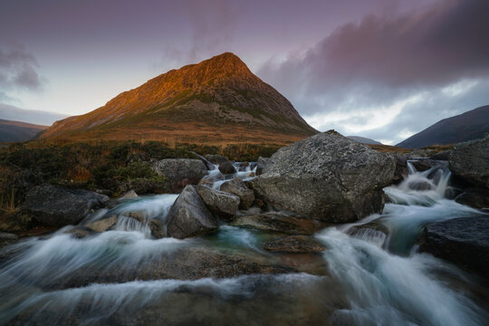 cascade waterfalls and fairy pools with the Devils point mountain located in the Cairngorms, highlands Scotland.
