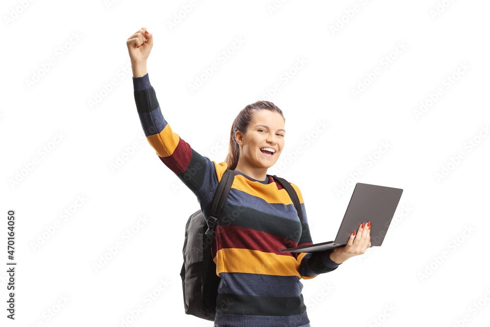 Wall mural happy female student holding a laptop and raising arm