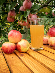 apple juice in the glass with apples near