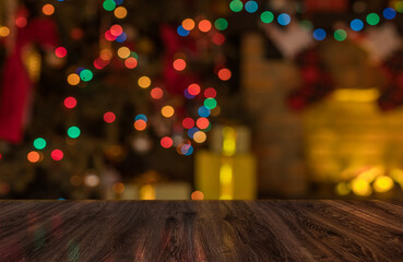 Many gift boxes near the Christmas fireplace in a festive interior of a Log Cabins with wooden walls. Mantelpiece with candles, Christmas wreath with bells