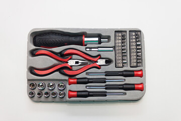 Universal screwdriver set with replaceable bits on a light background.
