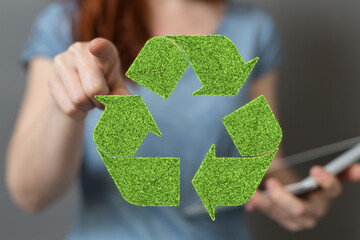 hand holding green recycle symbol