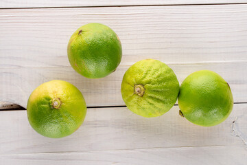 Several fragrant bergamots on a wooden table, close-up, top view.