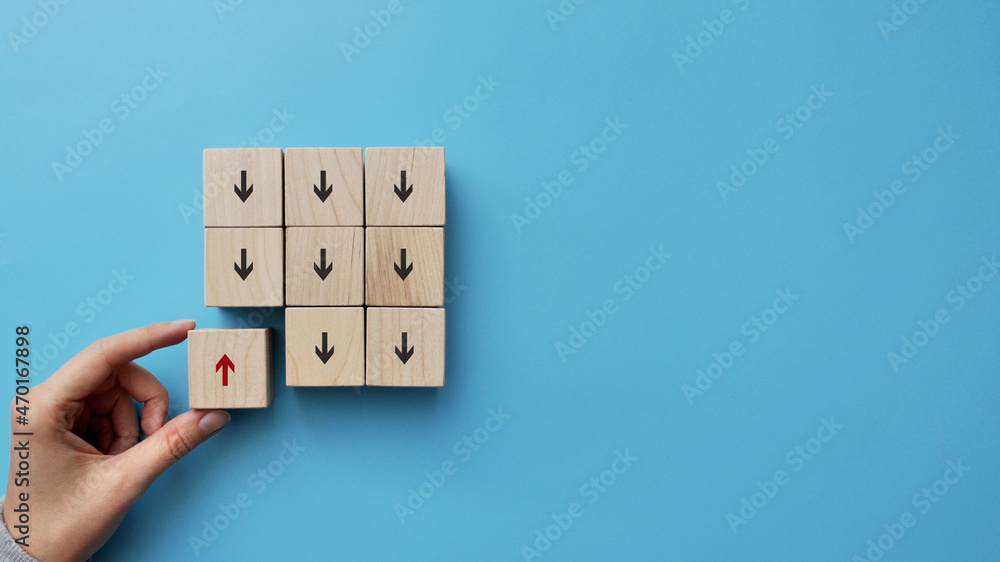 Poster many arrows point down and one moves up. a symbol of choosing a different path in business and life