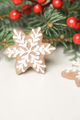 Christmas decoration. Christmas tree branches and homemade decorated Christmas cookies, close up image.