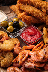 Top view on assorted deep fried beer snacks appetizer set with sauces