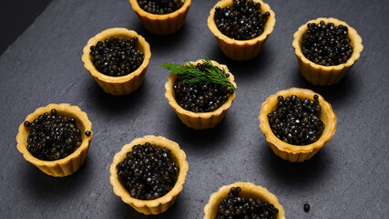 natural black caviar in tartlets close-up