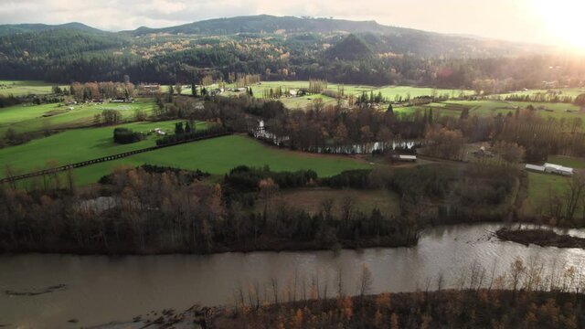 Drone Flying Over River with Rural Countryside in Fall Season