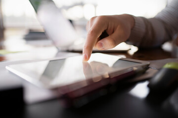 Workplace in a bright office. A man makes a financial report in the company. Surf the Internet on a laptop. The economist considers the costs of a startup.