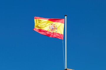 Flag of spain on the mast blowing in the wind