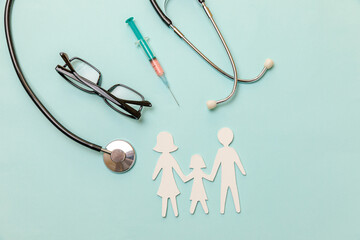 Family health care therapy medical concept. Family cutout symbol model stethoscope glasses syringe on blue background. Health check up life insurance concept. Clinic hospital for parents child banner.