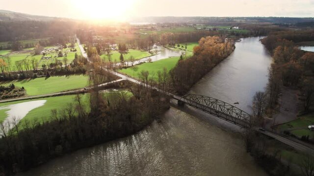 Rustic Metal Bridge at Rural Countryside River Crossing Aerial with Dramatic Natural Light