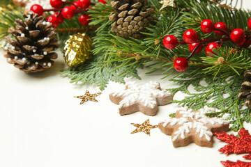 Christmas decoration. Christmas tree branches and homemade decorated Christmas cookies, close up image.