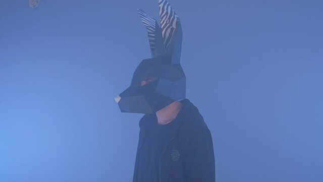 The guy in the mask of a hare. the guy in the haze. the guy shakes his head 