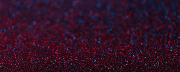 Abstract blurred dark blue red magic glitter background with copy space.