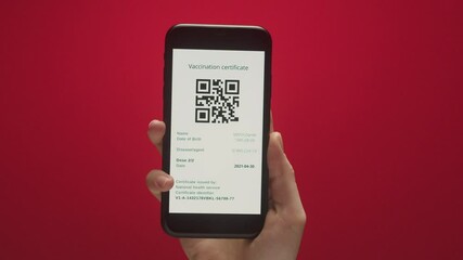 Woman show on phone vaccination passport with qr code, international coronavirus covid 19 vaccine certificate on mobile device, green zone. 